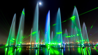 A long-term exposure image late into the wee hours of the morning during a video shoot of IMAGINE-Dubai Festival City. The stilness of the water and the moonlight allowed us to see the form of the water assets and captured a moment in time. The green hue from the lasers in the finale scene.
